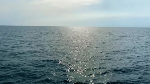 Tranquil Ocean View From the Stern of a Moving Ship at Sunset Stock Footage 267574542