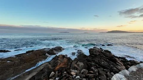 A Tranquil Ocean View at Sunset Casting Soft and Warm Hues Over the Waters .. Stock Photos