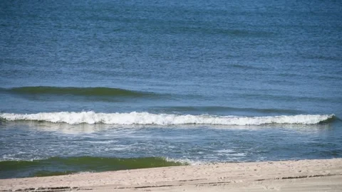 Tranquil ocean waves lapping pristine sandy shore Stock Footage 305703057