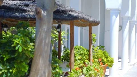 A tranquil outdoor dining area surrounded by plants in 4K slow motion 120fps Stock Footage 292760433