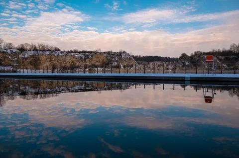 Tranquil Outdoor Pool with Sky Reflection Stock Photos