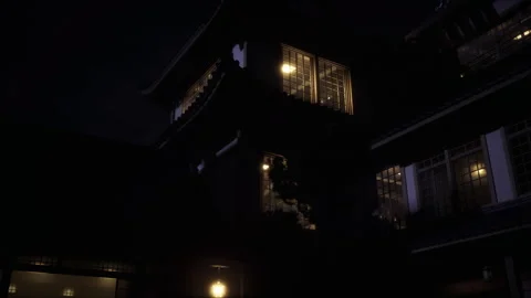 Tranquil outdoor setting featuring softly glowing windows and quiet shadows Stock Footage 343616715
