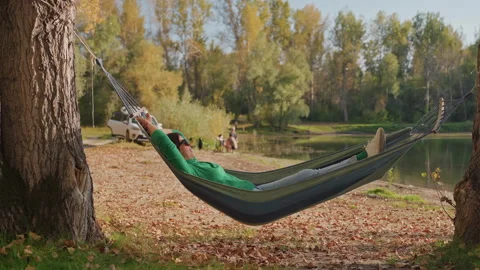 Tranquil outdoor setting featuring woman enjoying peaceful waters. Peaceful Stock Footage 345156729