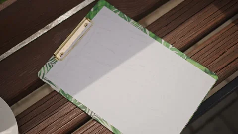 Tranquil outdoor workspace experience. Serene morning setting with paper and Stock Footage 346544377