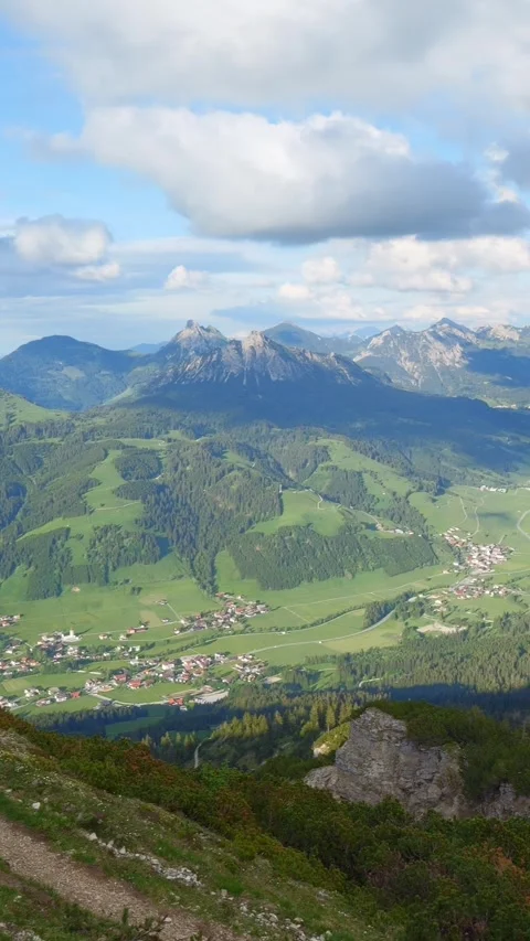 Tranquil Panoramic Views of Lush Green Hills, Majestic Mountain Peaks, and Cl Stock Footage 309229064