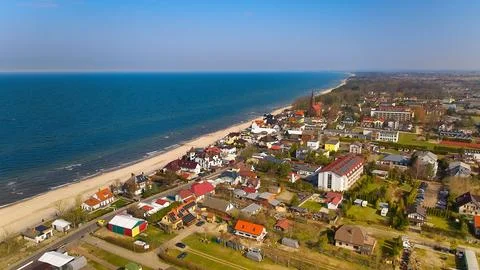 Tranquil Polish seaside with soft waves and Sarbinowos coastline in daylight. Stock Photos