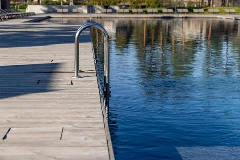 A Tranquil Reflection of Nature: A Close-Up View of a Modern Poolside with a Stock Photos