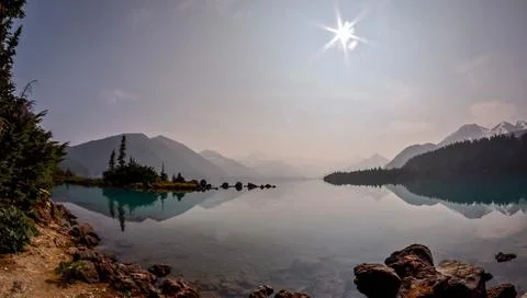 Tranquil Reflections on Garibaldi Lake Surrounded by Mountains Stock Photos