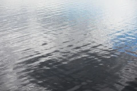 Tranquil Rippling Water Surface Reflecting Sky Light and Cloud Patterns Stock Photos