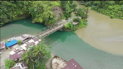 Tranquil river confluence at Agua Clara with a rustic bridge Stock Footage 329828233