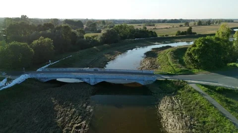 Tranquil River Flowing Beneath Elegant Bridge Video stock 290819885