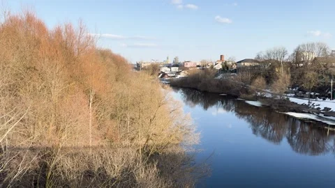A tranquil river flowing through the city, an early spring landscape  Stock Footage 331332816