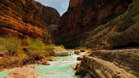 Tranquil river flowing through a rocky canyon. Stock Footage 88404543