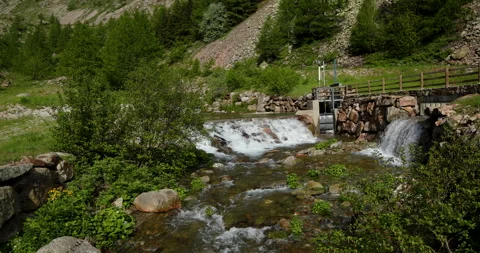 Tranquil river flows through a picturesque valley surrounded by lush greenery Video stock 314081934