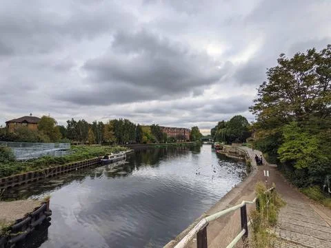 Tranquil River Lea Landscape Featuring Narrowboats, Riverside Walk, and Overcast Stock Photos