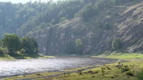Tranquil river meandering through serene forested hillsides Vídeo Stock 281769350
