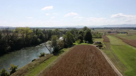 A tranquil river meanders through a landscape of farmlands and trees. Stock Footage 285773288