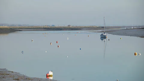 A tranquil river scene at low tide - River Crouch in Essex, UK. 4K tripod Stock-Footage 234724939