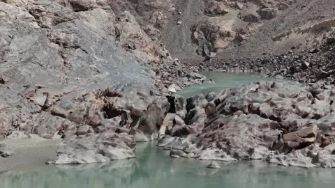 A tranquil river scene in a rugged landscape, highlighting natural beauty and 스톡 동영상 317957549