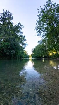 Tranquil River Scene Surrounded by Lush Greenery 스톡 사진