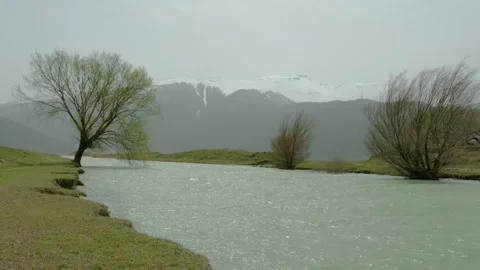 Tranquil River with Snow-Capped Mountains Stock Footage 282935725