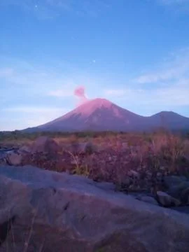 A tranquil river stream winds below Mount Semeru Stock Photos