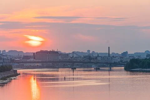 Tranquil river at sunset, orange sky reflection, small ripples, windy, rive.. 스톡 사진