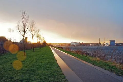 Tranquil Riverside Path at Sunset Stock Photos