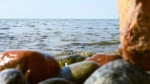 Tranquil rocky shoreline under clear sky Stock Footage 296370215