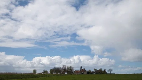 Tranquil rural village with dramatic clouds in blue sky, Sandfirden, Netherlands Stock-Footage 81349343