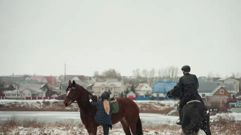 Tranquil rural winter scene of horseback riding with guidance. Peaceful Stock Footage 345176523