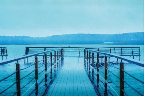 A tranquil scene captures mist hovering over a lake and mountains Foto stock