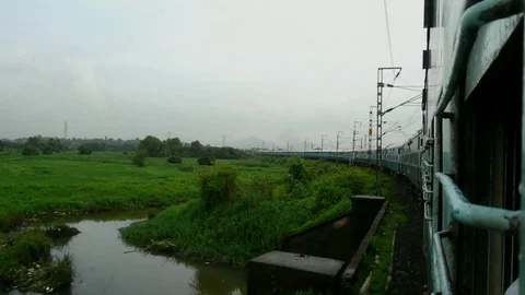 Tranquil Scenic greenery View from fast moving Indian train window, Mumbai India Stock Footage 99171143