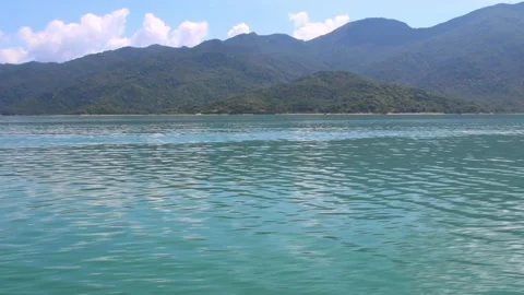 Tranquil Sea Surface with Mountain View in Tropical Region. Stock Footage 312089207