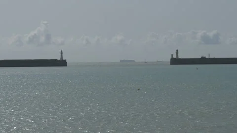 Tranquil sea surface with two lighthouses in the distance. Stock Footage 142512983