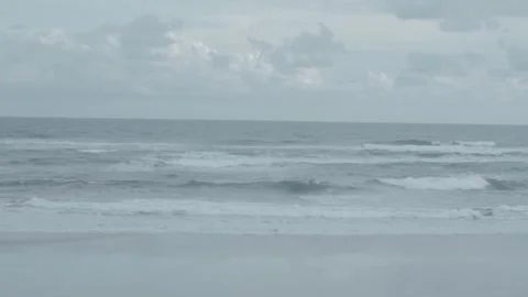 Tranquil Seascape with Calm Waves and Overcast Skies at the Beach Stock Footage 303340395