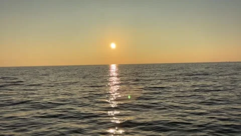 Tranquil Seascape with a Red Sun on the Horizon at Dusk Stock Footage 324789545