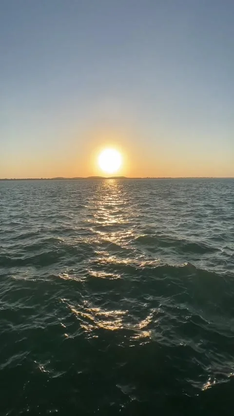 Tranquil seascape. Waves gently rolling in the blue ocean under a sky dotted Video stock 276598869