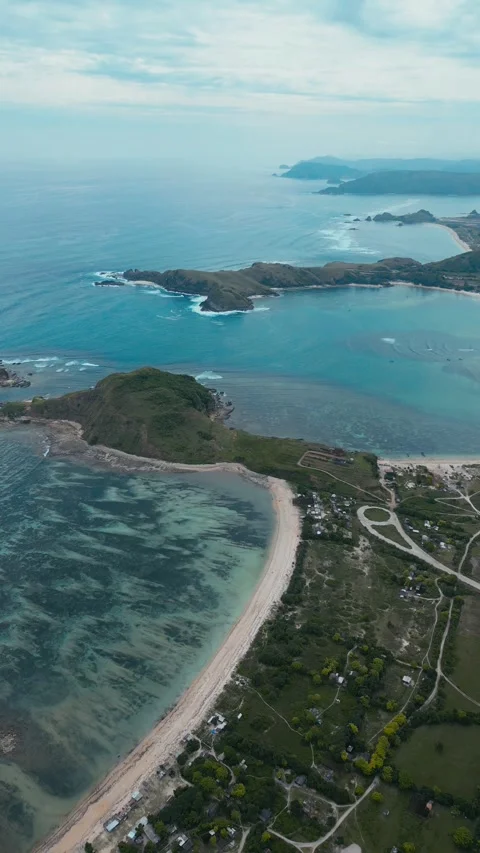 Tranquil Seaside Hamlet Surrounded By Colorful Coral Formations And Vegetation Stock Footage 328018928
