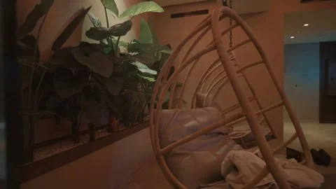 A tranquil seating area among plants 動画素材 335784432
