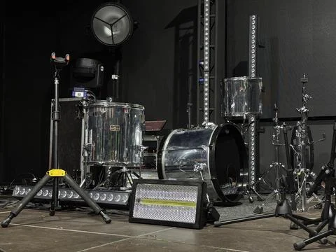 Tranquil setting with drums prior to show, Gentle lighting highlights equipment Stock Photos