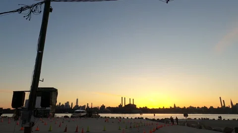 Tranquil Silhouetted Sunset view across East River NYC from Bushwick Brooklyn Stock Footage 153070378