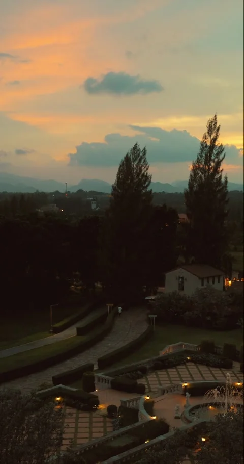Tranquil sunset over lush landscape with winding path, silhouetted Stock Footage 316598273