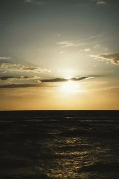 Tranquil Sunset Over the Ocean with Clouded Sky Stock Photos