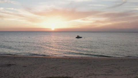 Tranquil Sunset Over Quiet Beach and Mooring Boat Stock Footage 310615273