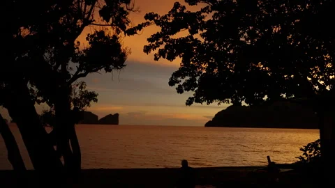 Tranquil Sunset Over Water Captured In Serene Frames Showcasing Silhouetted Vídeos de archivo 310053123