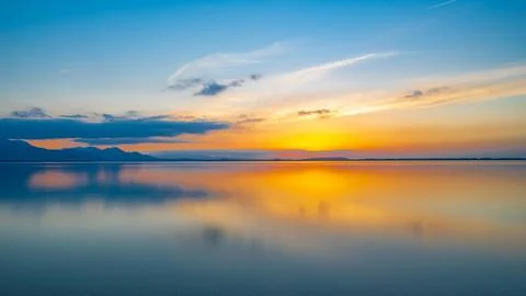 Tranquil Sunset Reflection on Calm Water Stock Photos