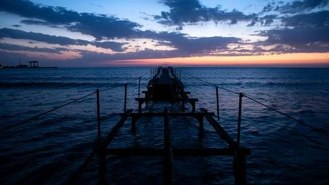 The Tranquil Sunset Reflection on the Ocean Pier Capturing the Beauty of Natures Stock Photos