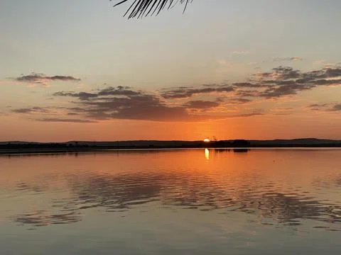Tranquil Sunset Reflection Over Lake Stock Photos