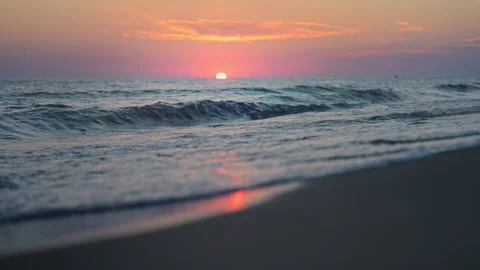 Tranquil sunset by the sea, cinematic waves crashing in slow motion Stock Footage 318104025